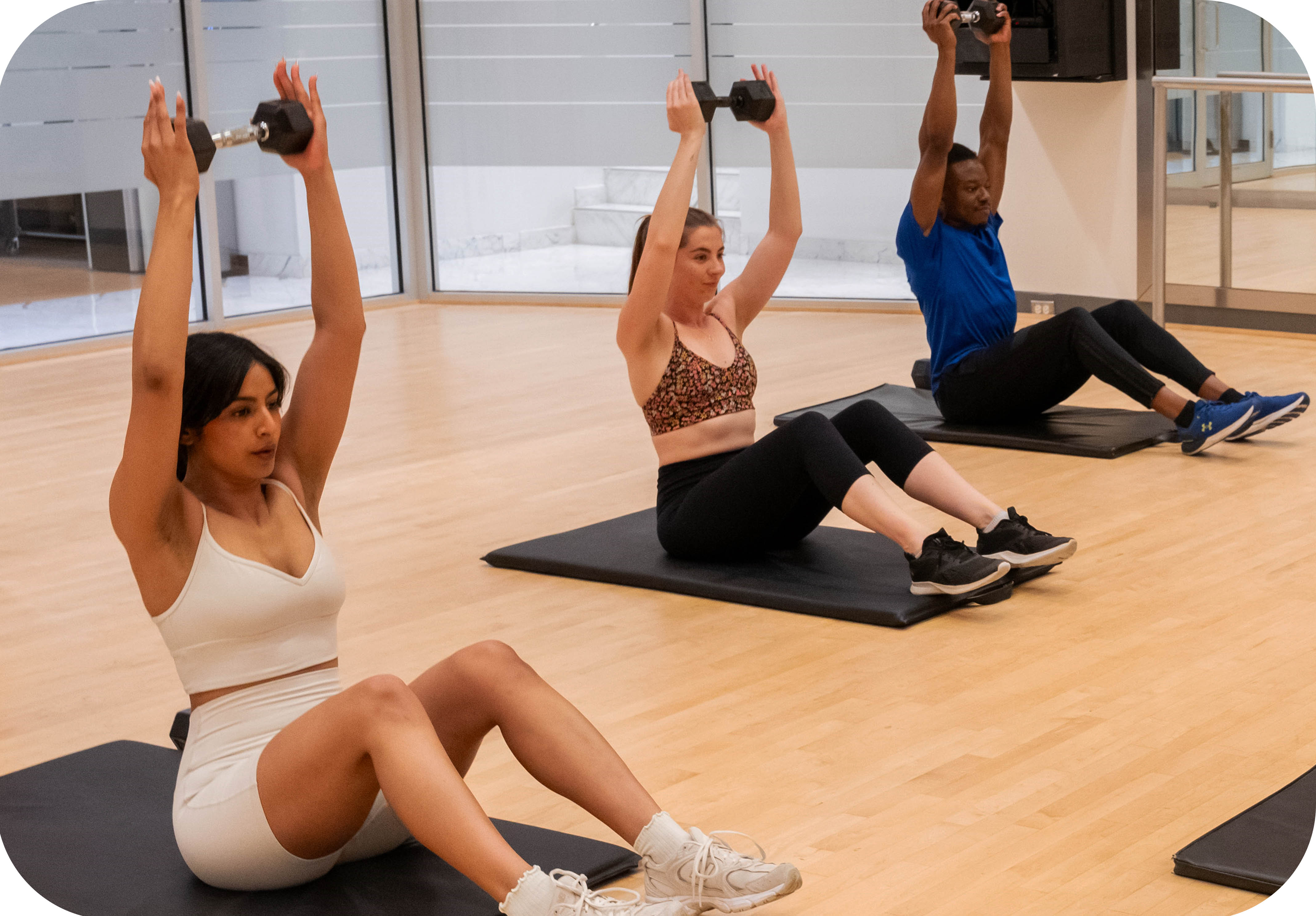 Class of men and women doing a core group fitness workout in the Adelaide Club's Fusion Studio