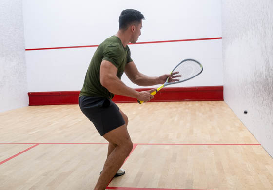 Young fit man playing squash on the squash courts at the Adelaide Club as part of our Thursday Night Squash Beer League