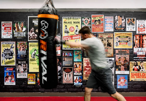 Fit man doing some boxing with the punching bag in the Strength Gym at the Adelaide Club